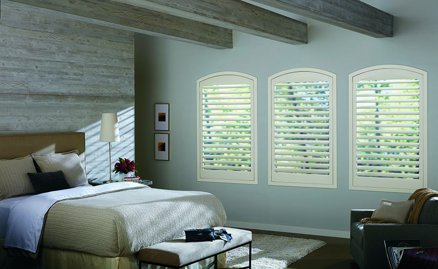 plantation shutters on arched windows in bedroom Fort Myers FL