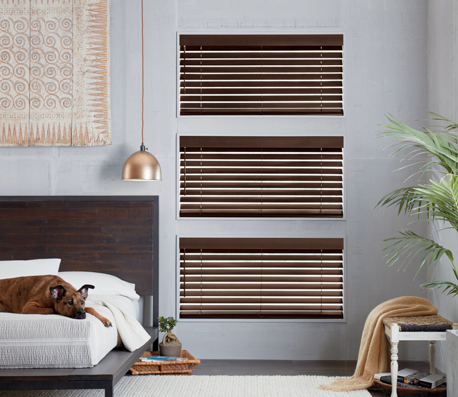 rustic bedroom with dog and hunter douglas brown wood blinds Naples