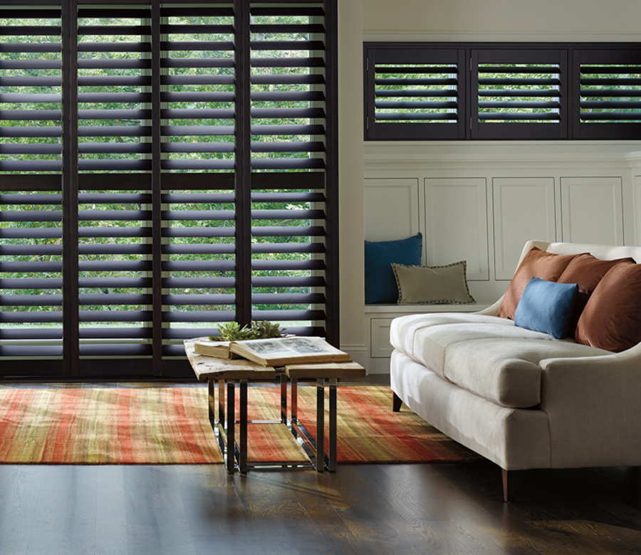 traditional living room with black hardwood shutters on large windows Hunter Douglas Fort Myers