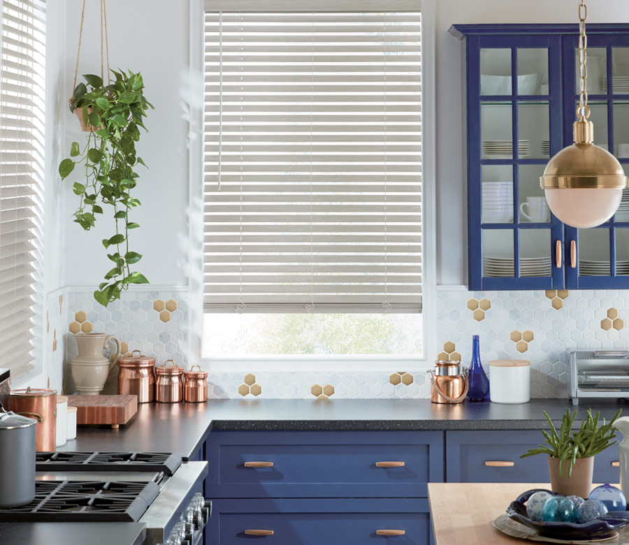 kitchen with navy blue detail and hunter douglas everwood blind Naples