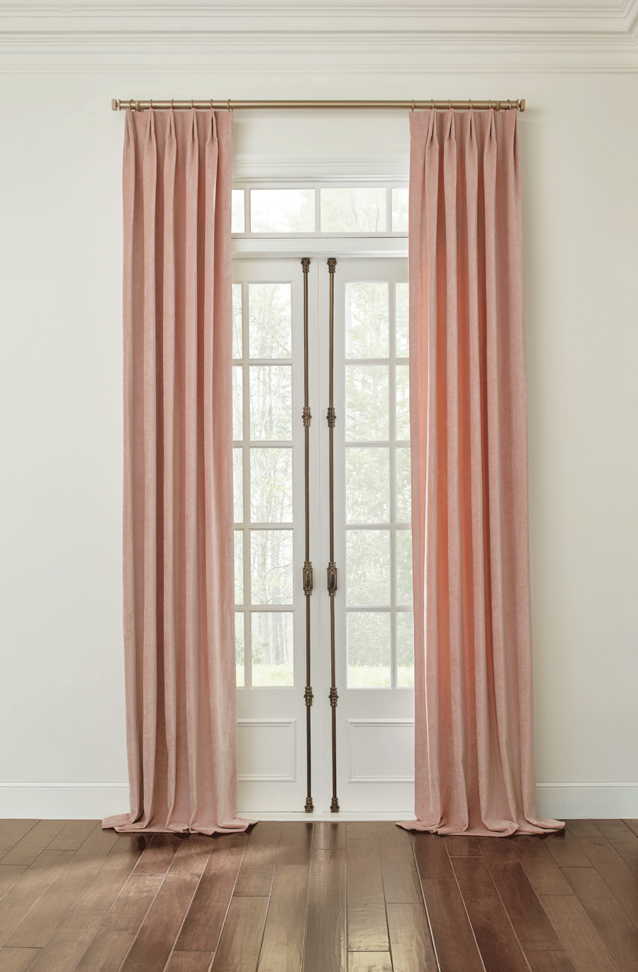 drapes on french doors with gold hardware that puddle on the floor 