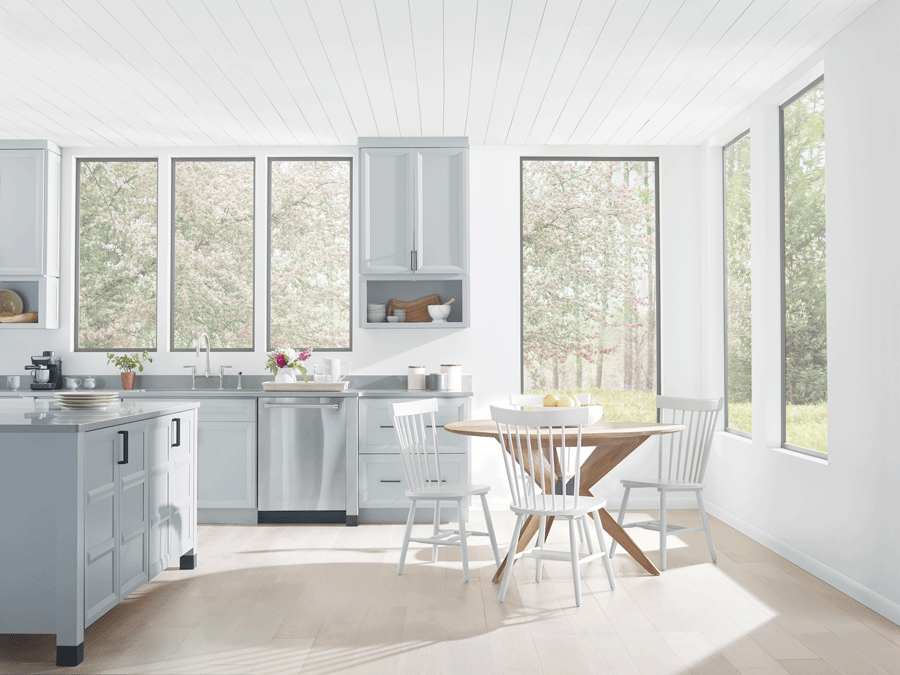 Kitchen with no window treatments is drowning in light.