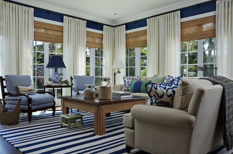 Woven wood shades in blue living room.