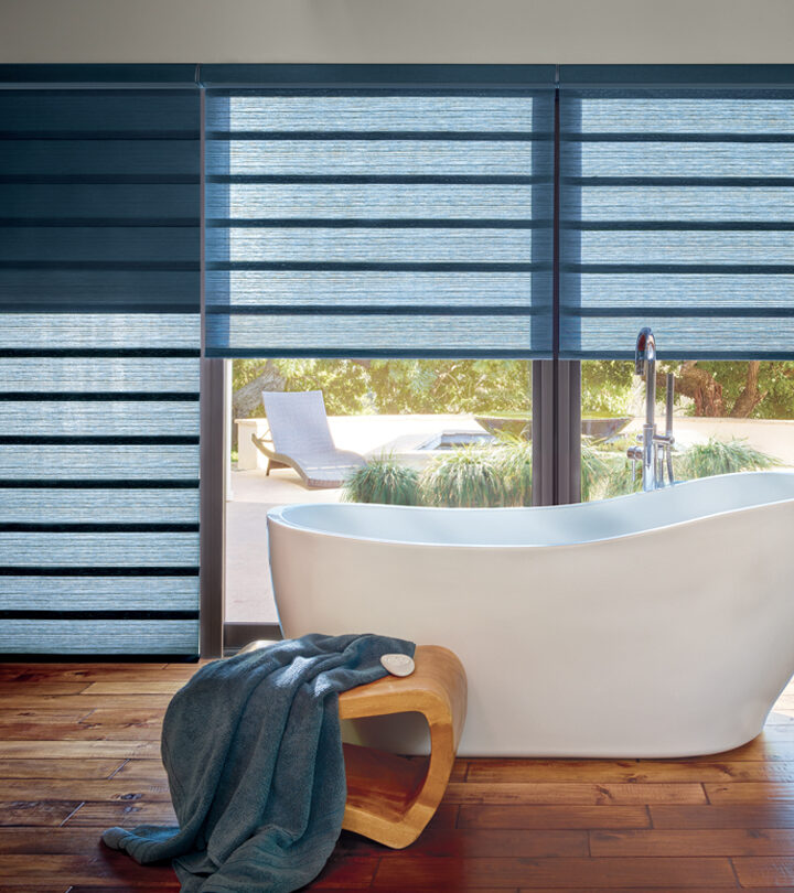 tall windows in master bath with jewel toned blue roman shades