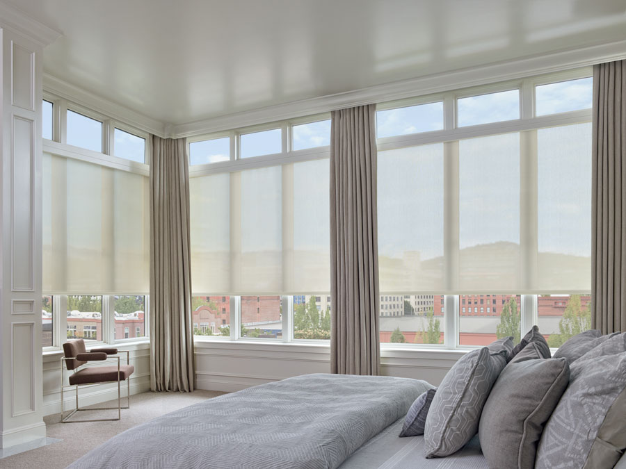 Largest windows with designer screen shades in bedroom of ft Myers home