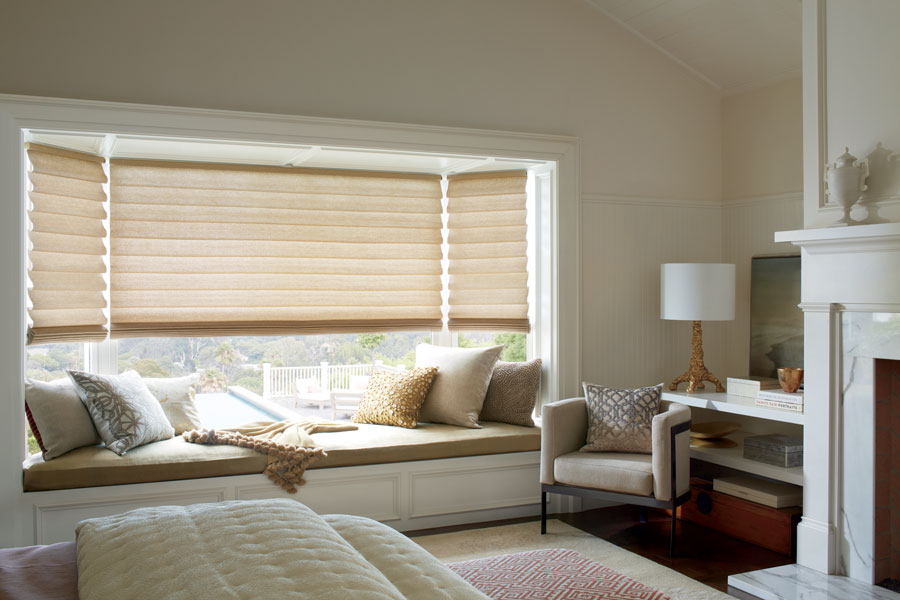 bay window covered with gold fabric shades in Fort Myers Fl bedroom 