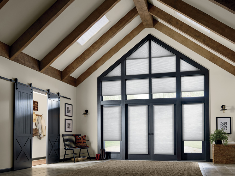 open floor plan home with high angled ceilings and angled windows covered with honeycomb shades in Fort Myers FL