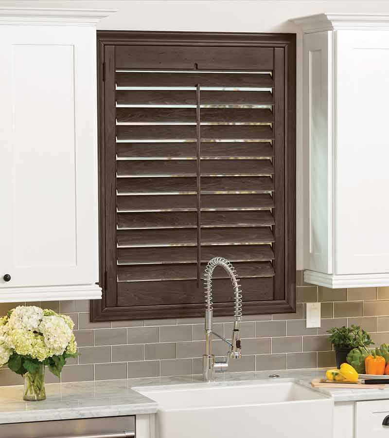 dark kitchen shutters behind sink in Naples, FL