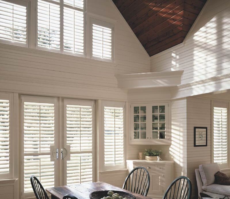 white shutters for renovated farmhouse in arched and angled windows in Fort Myers, FL