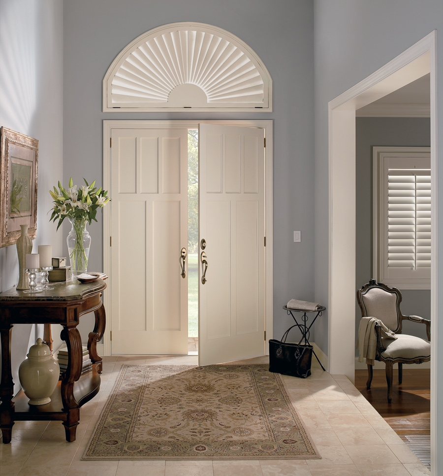 custom plantation shutters on front door arched window in Naples FL home