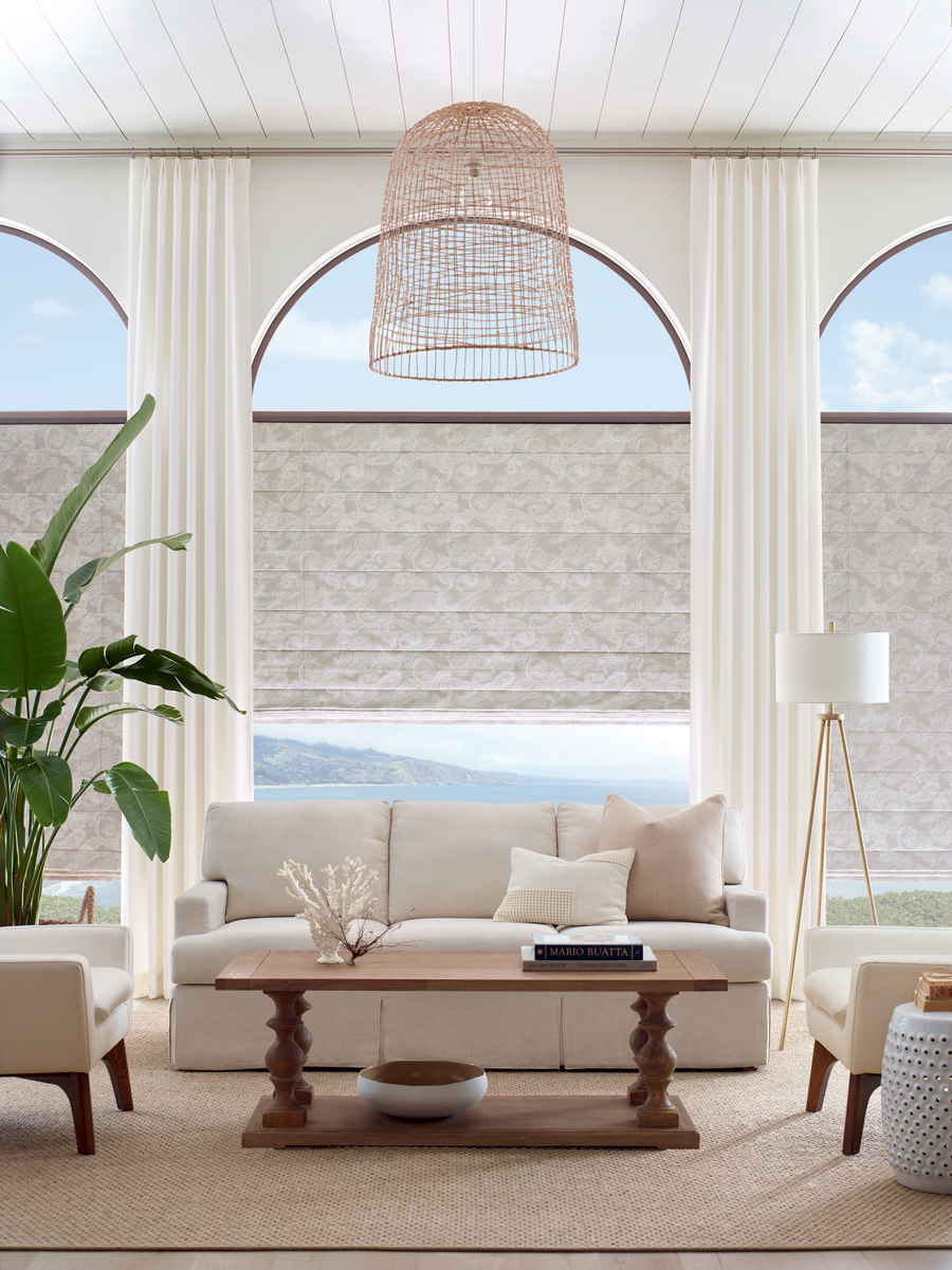 Living room with roman shades on arched windows