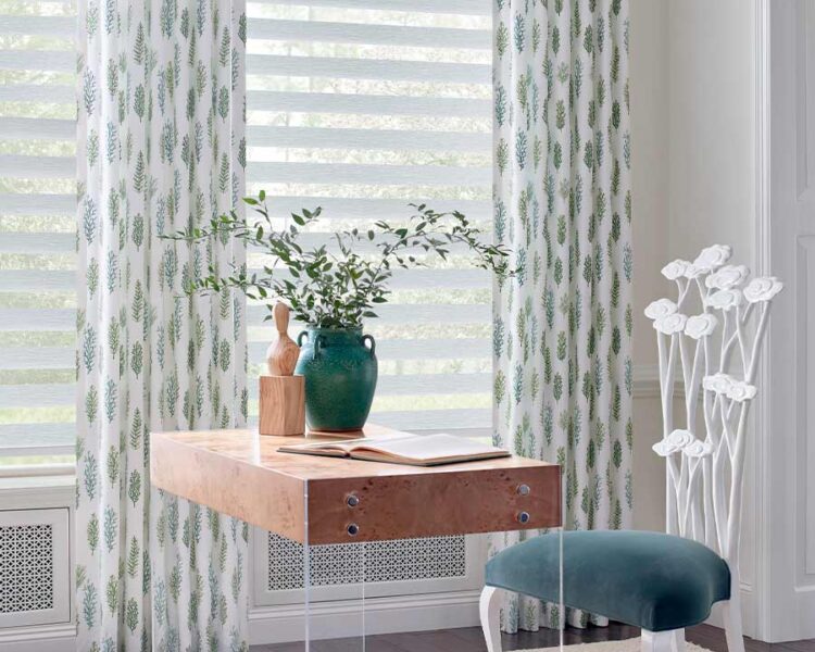 home office with banded dual opacity shades and floor to ceiling curtains with green and blue ferns