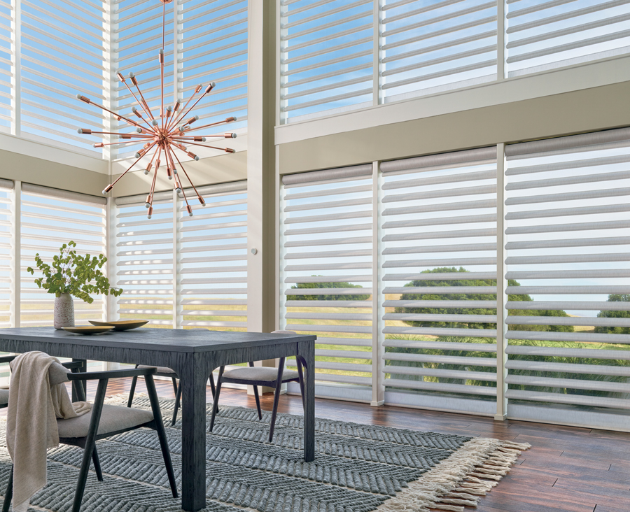 dining room with tall windows covered in sheer shades