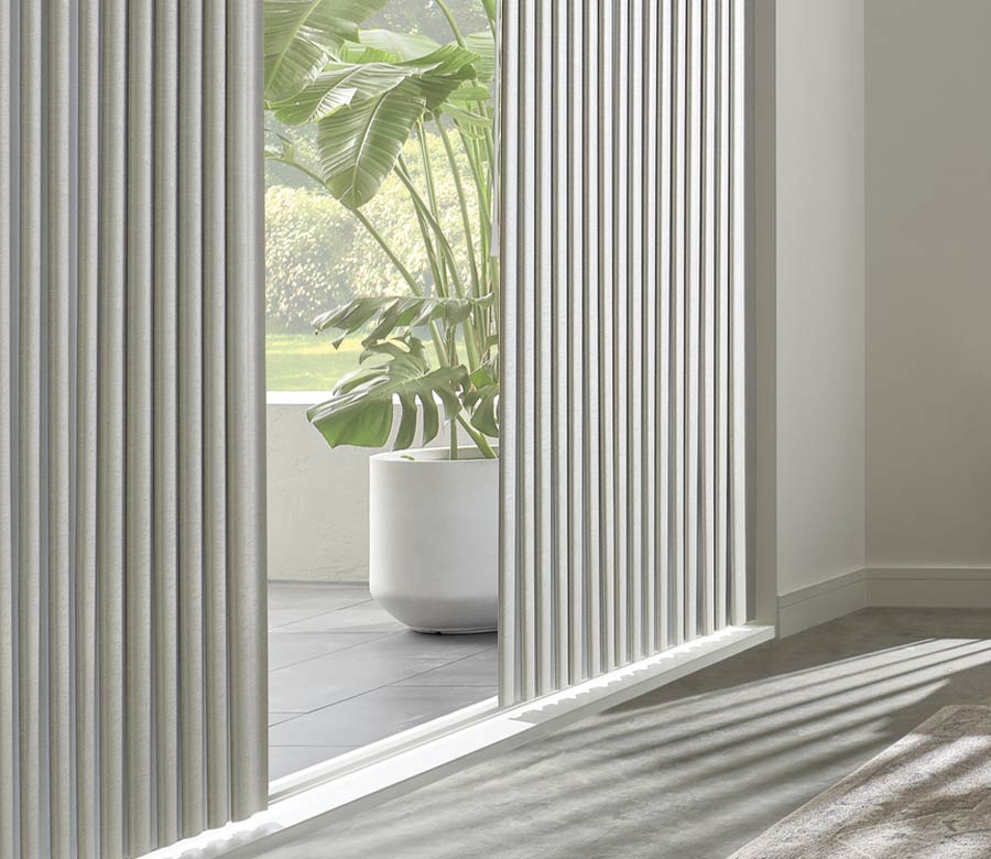 angled view of glass door with shadings looking into tropical garden space Fort Myers, FL