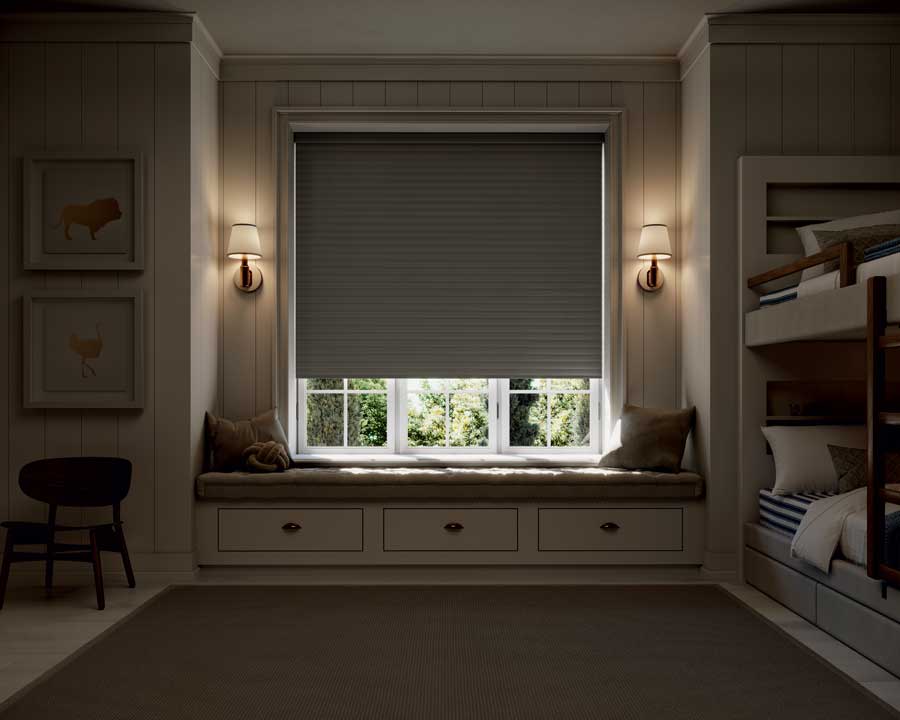 Window seat in bedroom with room darkening shades