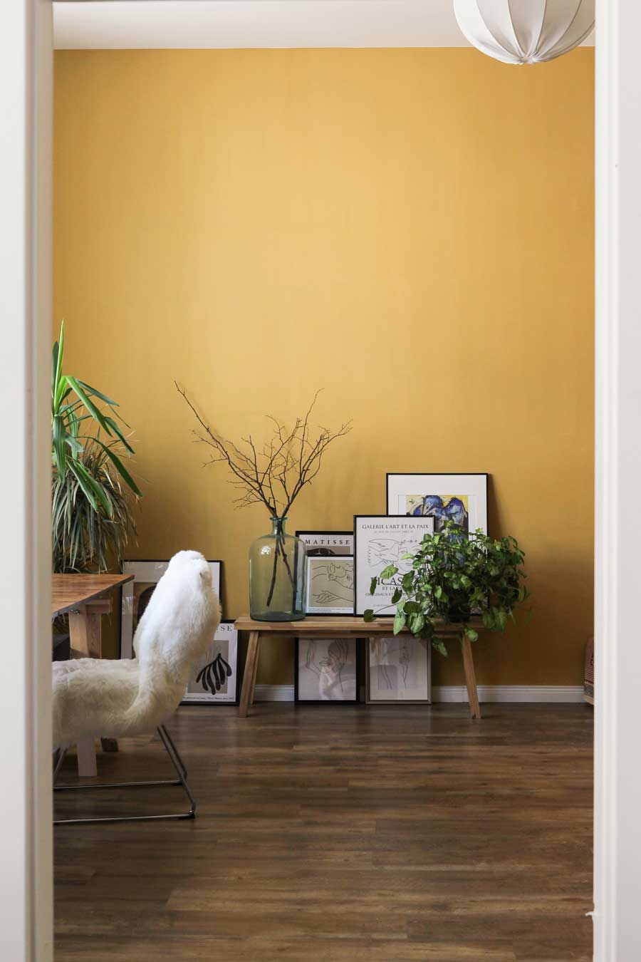 Yellow room with neutral and plant accents