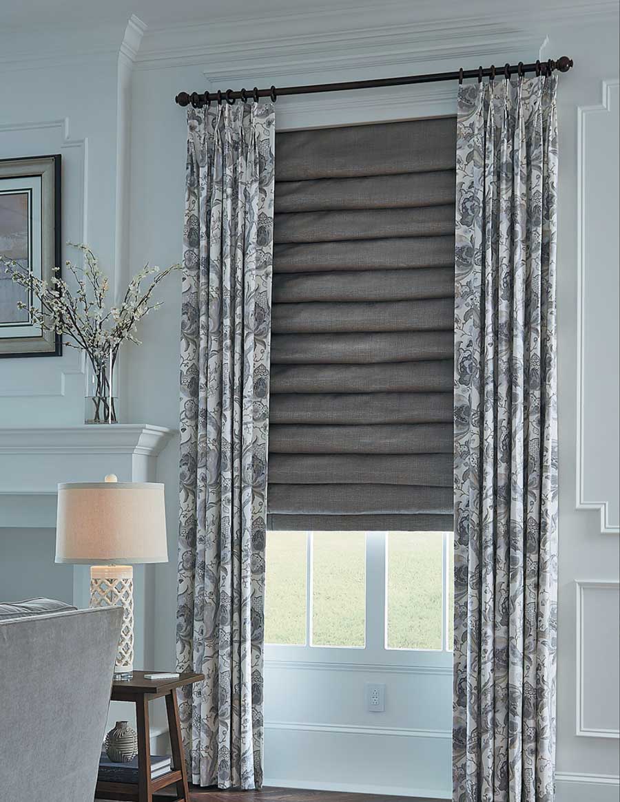 gray roman shades and patterned draperies