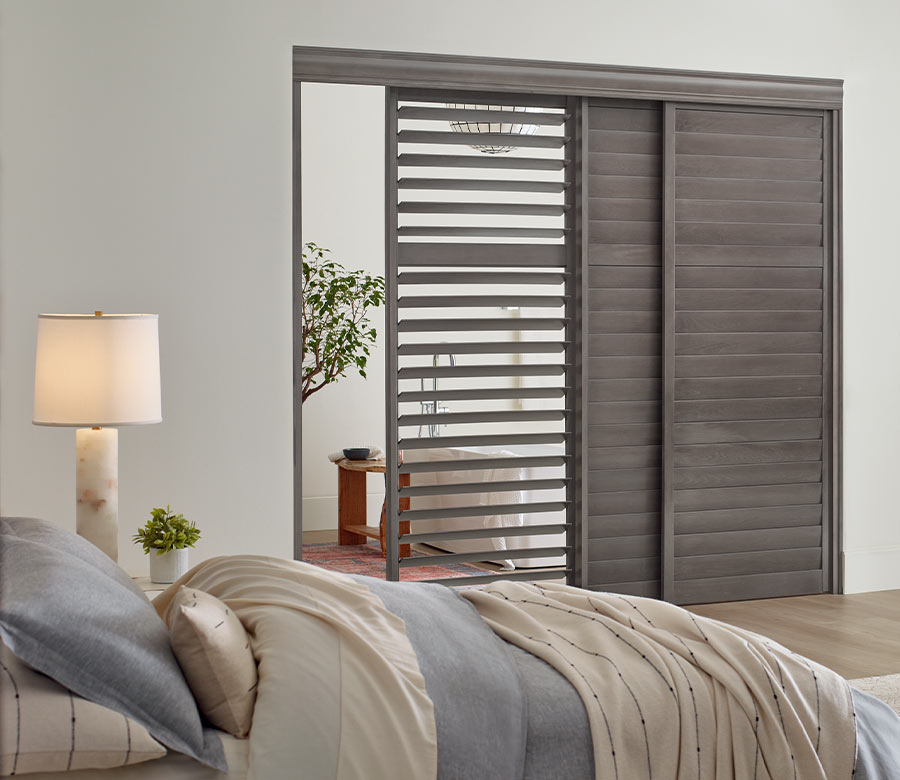 gray wood shutters on sliding glass door for guest bedroom