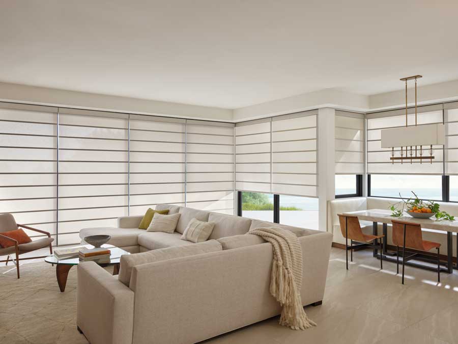 Alustra® Architectural Shades on floor to ceiling windows in a living room