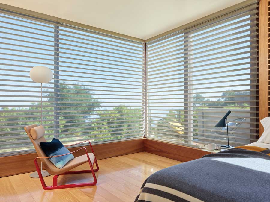 Silhouette® Windows Shades in a bedroom with floor to ceiling windows