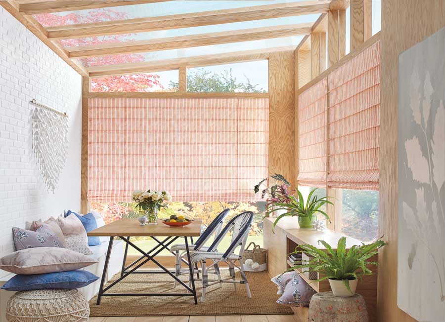 sunroom windows with patterned folding roman shades