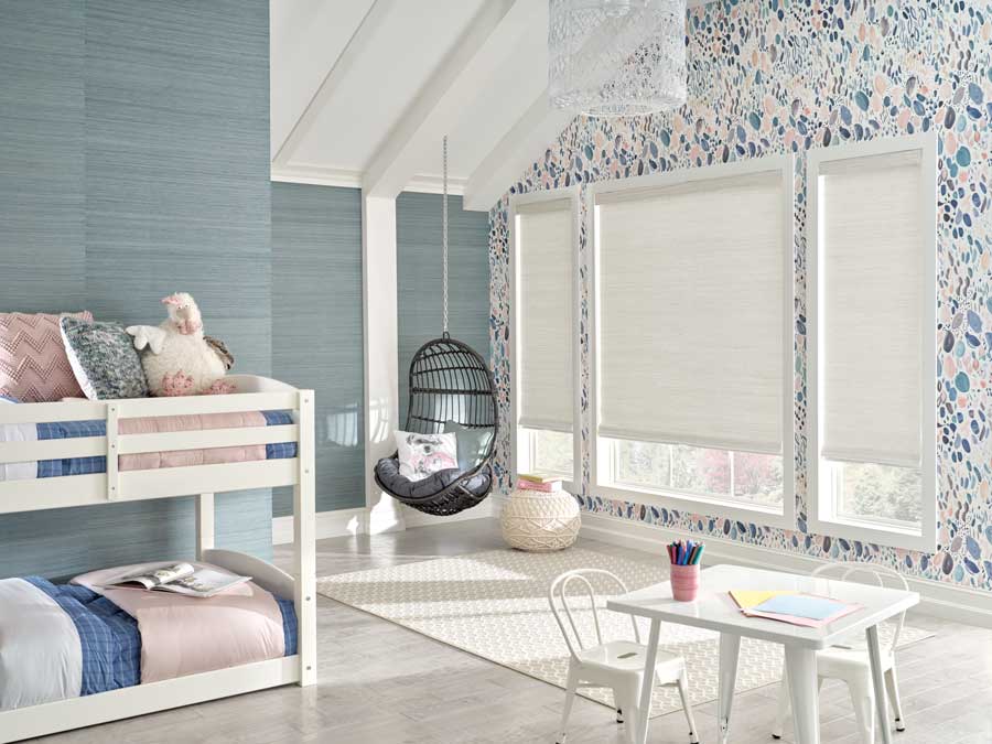 child's room with bunk beds, peach and blue wallpaper and cream woven shades