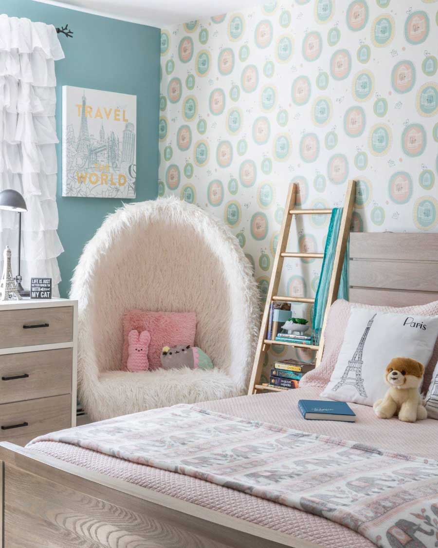 wallpaper accent wall in a girl's bedroom with blue and pink