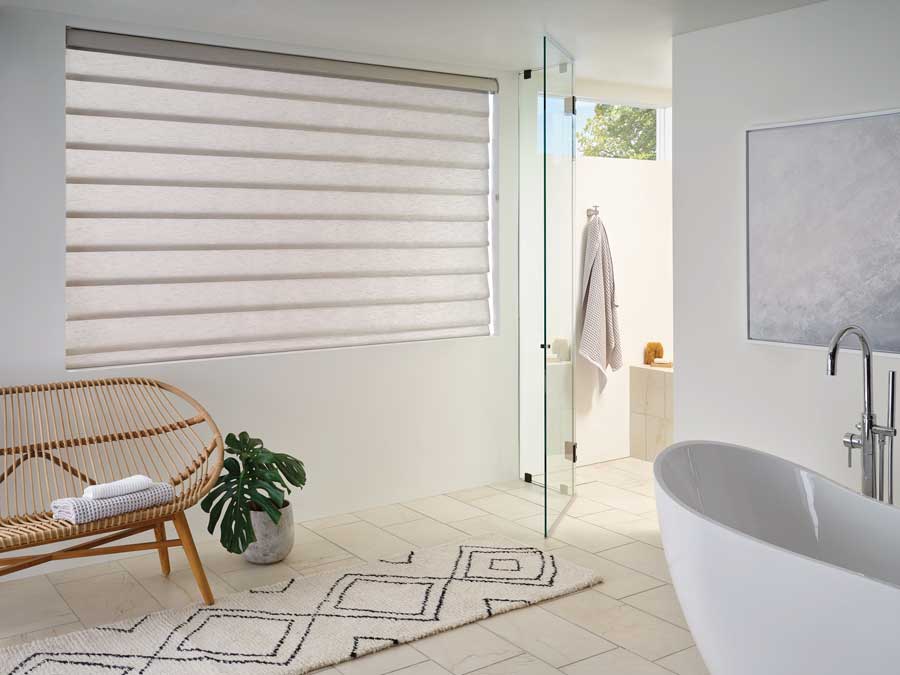 rolling roman shades in bathroom with light filtering shades