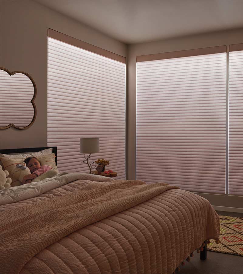 aura illuminating blinds in bedroom with roller shades