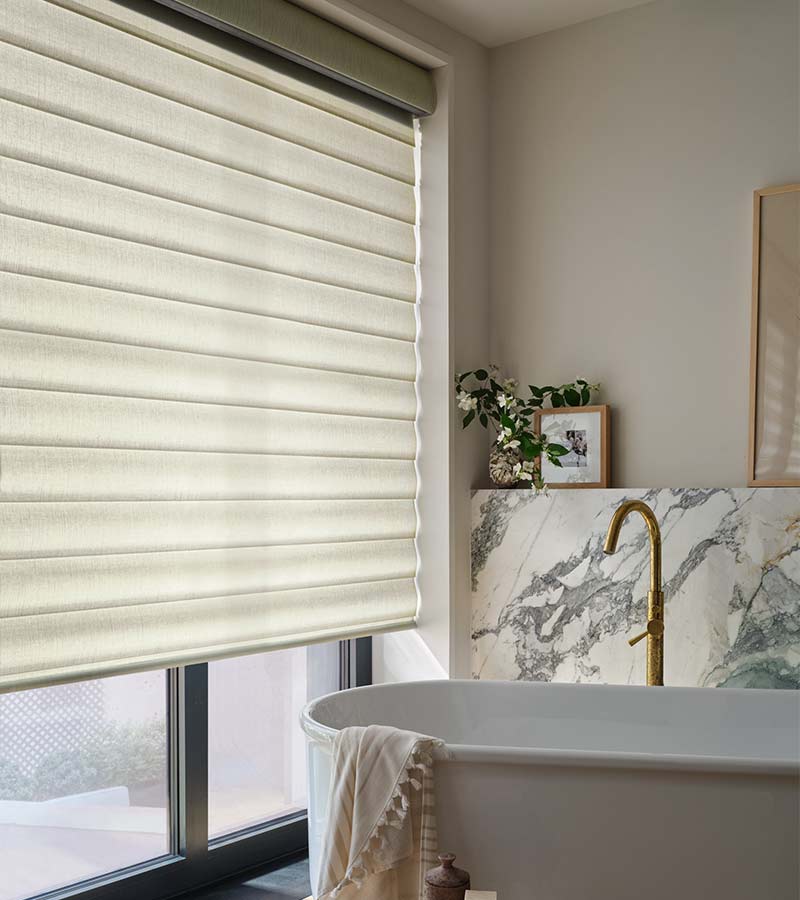 large-windows-bathroom-pirouette-hunter-douglas-custom-window-shades-blinds-at-home-blinds-and-decor bathroom with white pirouette shades and white soaking tub