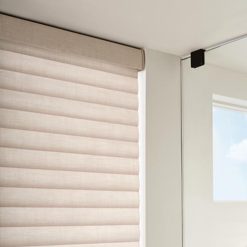 Sonnette cellular roller shades on corner windows with light-filtering fabric
