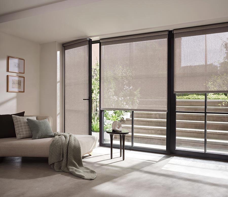 sheer designer shades on glass doors leading to outside